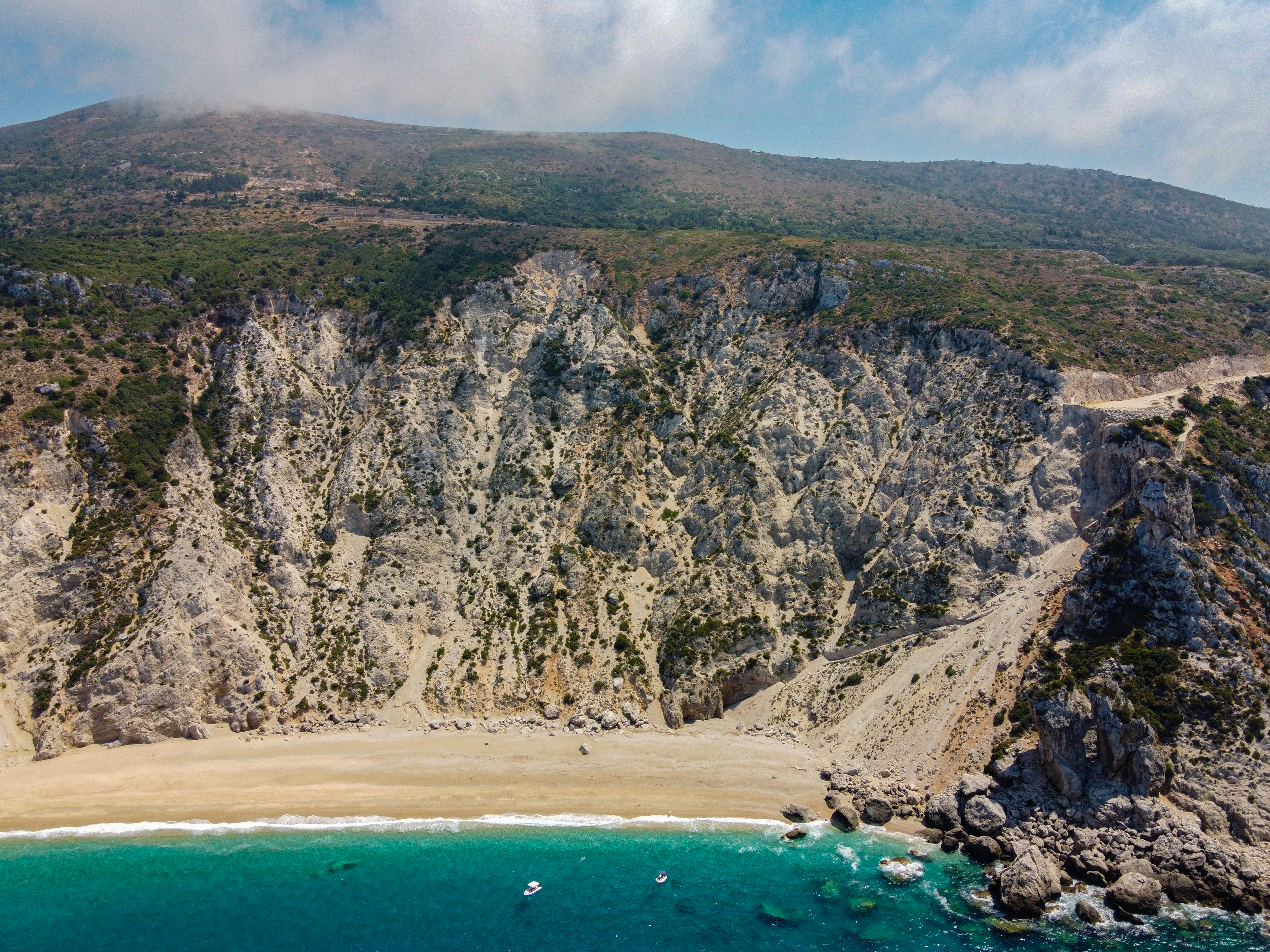 View of Platia Ammos beach from the West. Scree cones or screecan be seen caused by earthquakes